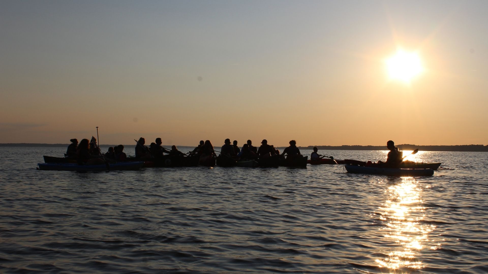 Campers boating during sunset