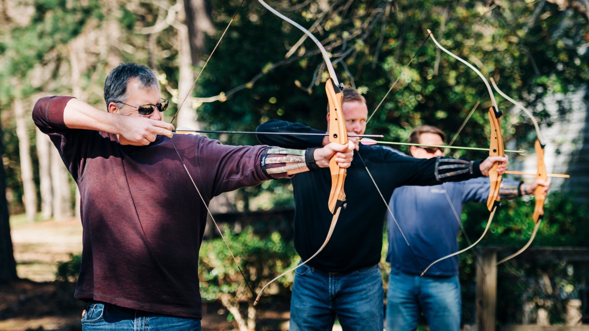 Adults participate at the archery range
